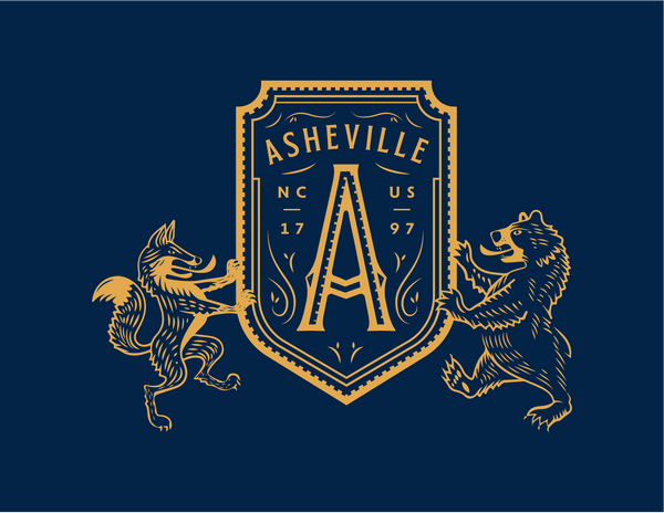 close of up t-shirt of bear and fox holding a shield with "A" for Asheville, North Carolina
